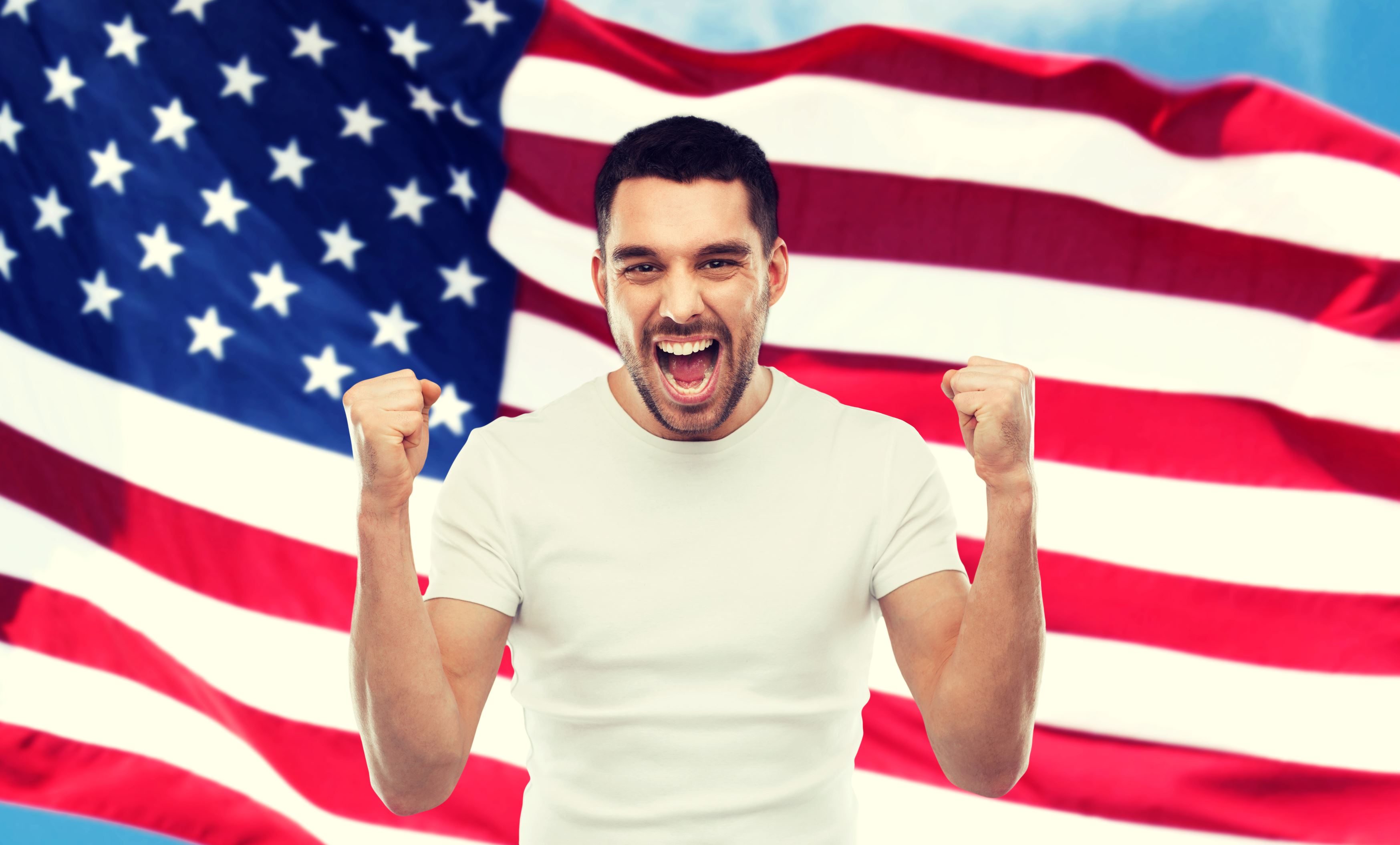 happy man standing in front of US Flag