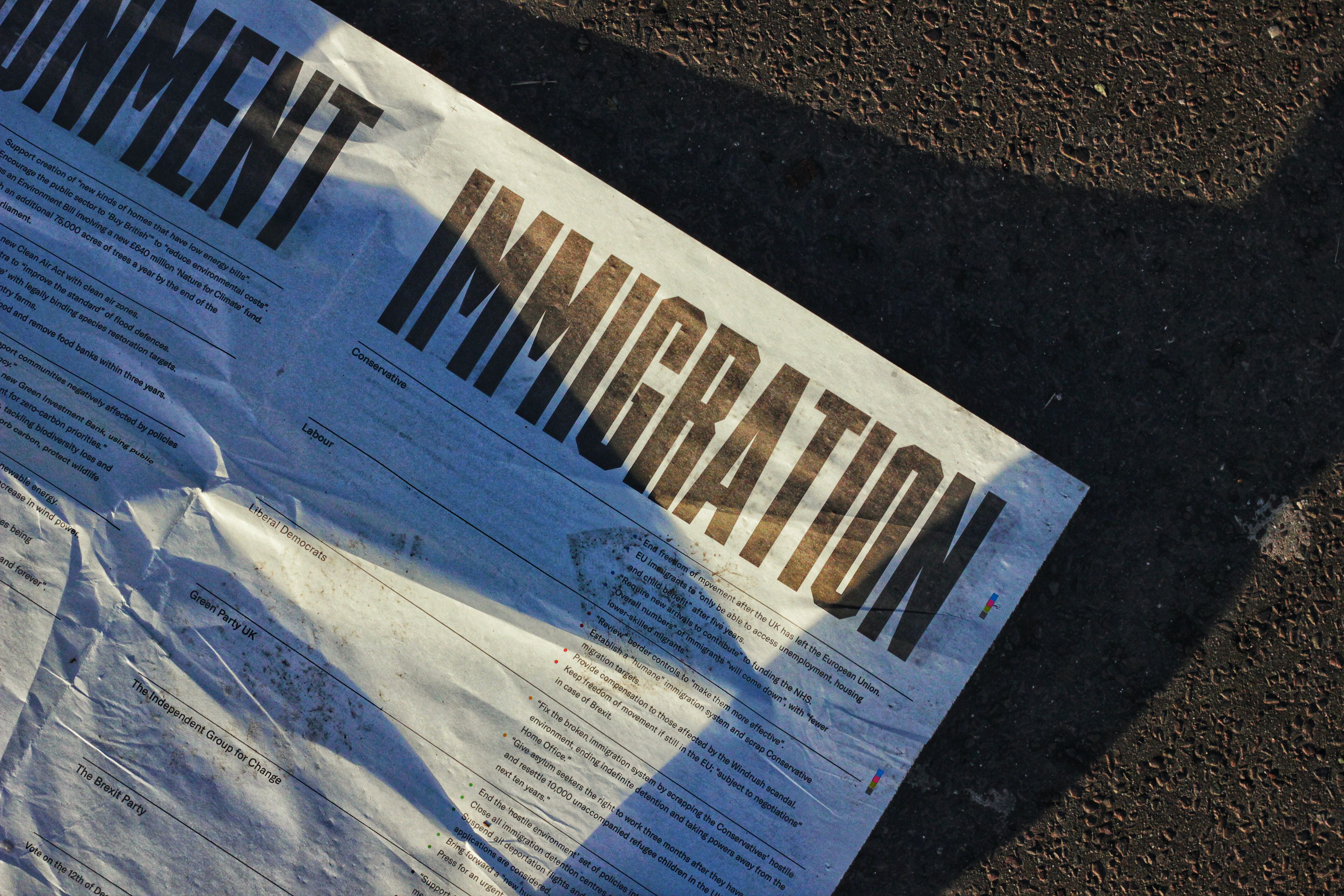 immigration written on a newspaper